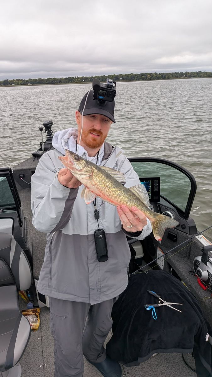 Scott with a walleye at the console, GoPro and headset mic on