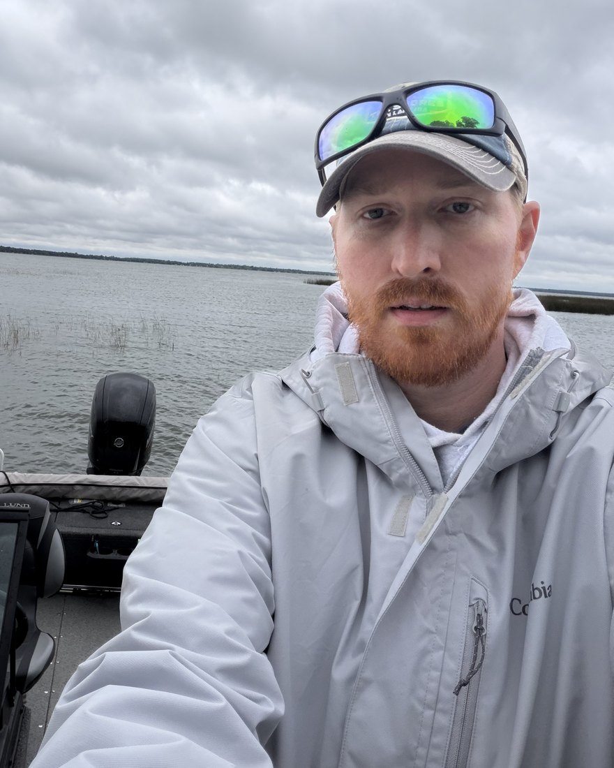 Scott from North Star Anglers in his boat at the dock on a cloudy Minnesota lake